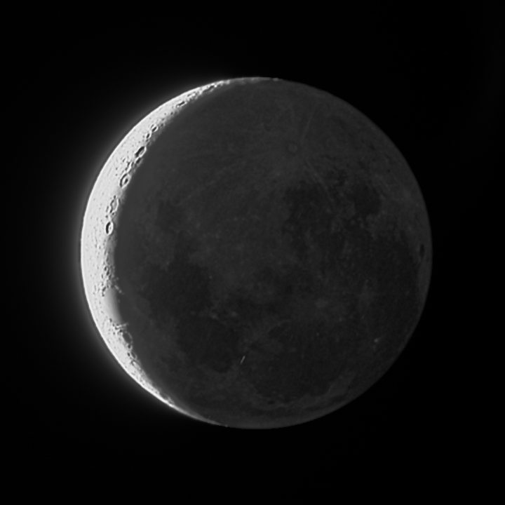 The combined crescent and softly lit dark side in black and white